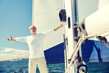 Image showing senior man on sail boat or yacht sailing in sea