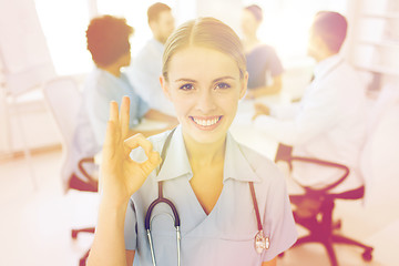 Image showing happy doctor over group of medics at hospital