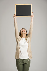 Image showing Woman showing something on a chalkboard