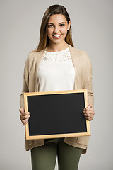 Image showing Woman showing something on a chalkboard