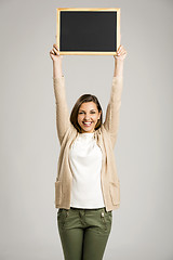 Image showing Woman showing something on a chalkboard