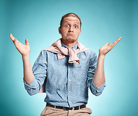 Image showing The surprised young man over blue background