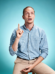 Image showing The surprised young man over blue background