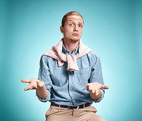 Image showing The surprised young man over blue background