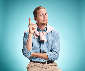 Image showing The serious young man over blue background