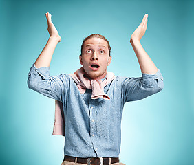 Image showing The surprised young man over blue background