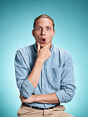 Image showing The surprised young man over blue background