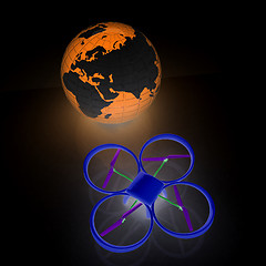 Image showing Quadrocopter Drone with Earth Globe and remote controller on a w