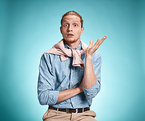 Image showing The surprised young man over blue background