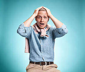 Image showing The surprised young man over blue background