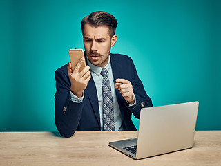 Image showing Sad Young Man Working On Laptop At Desk