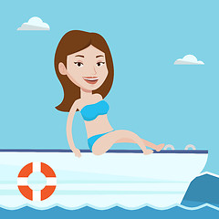 Image showing Young happy woman tanning on sailboat.