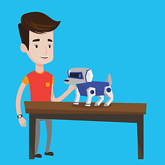 Image showing Happy young man playing with robotic dog.