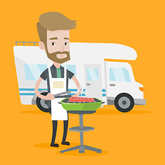 Image showing Man having barbecue in front of camper van.