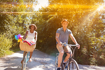 Image showing Young multiethnic couple having a bike ride in nature