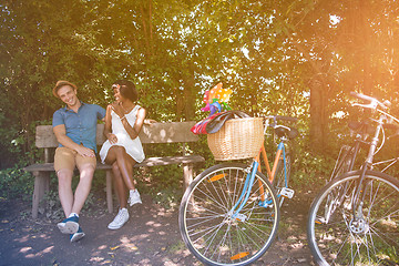 Image showing Young multiethnic couple having a bike ride in nature