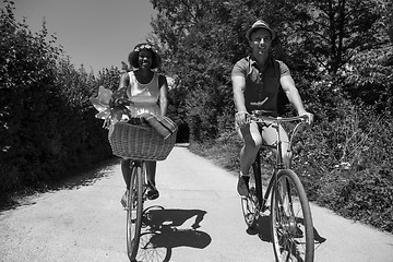 Image showing Young multiethnic couple having a bike ride in nature