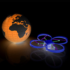 Image showing Quadrocopter Drone with Earth Globe and remote controller on a w