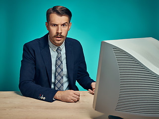 Image showing Sad Young Man Working On computer At Desk