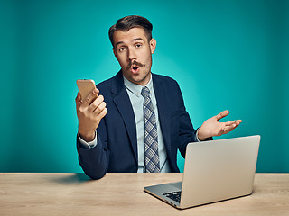 Image showing Sad Young Man Working On Laptop At Desk