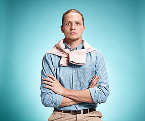 Image showing The serious young man over blue background