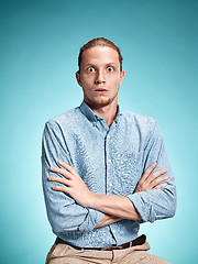 Image showing The surprised young man over blue background