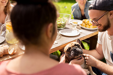 Image showing happy friends having dinner at summer garden party