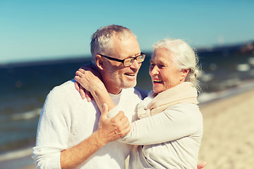 Image showing happy senior couple hugging on summer beach