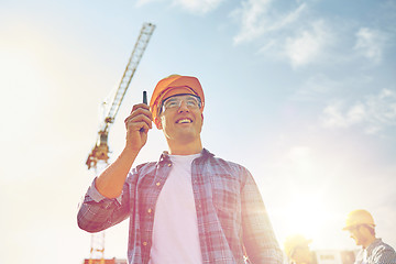 Image showing builder in hardhat with walkie talkie