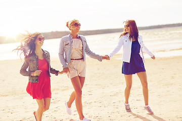 Image showing group of smiling women in sunglasses on beach