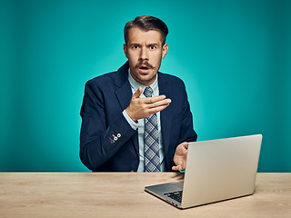 Image showing Sad Young Man Working On Laptop At Desk