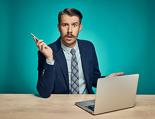 Image showing Sad Young Man Working On Laptop At Desk