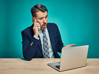 Image showing Sad Young Man Working On Laptop At Desk