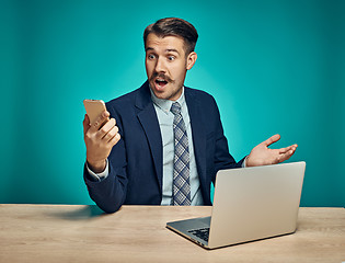 Image showing Sad Young Man Working On Laptop At Desk