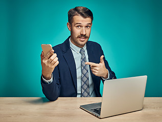 Image showing Sad Young Man Working On Laptop At Desk