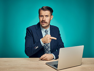 Image showing Sad Young Man Working On Laptop At Desk