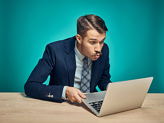 Image showing Sad Young Man Working On Laptop At Desk