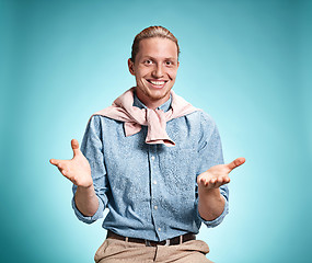 Image showing Happy excite young man smiling over blue background