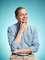 Image showing Happy excite young man smiling over blue background