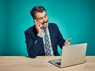 Image showing Sad Young Man Working On Laptop At Desk