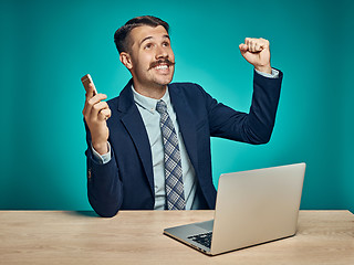 Image showing Sad Young Man Working On Laptop At Desk