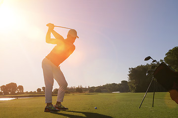 Image showing golf player hitting shot with club