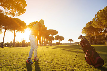 Image showing golf player hitting shot with club