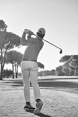 Image showing golf player hitting shot with club