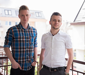 Image showing two young men standing at balcony