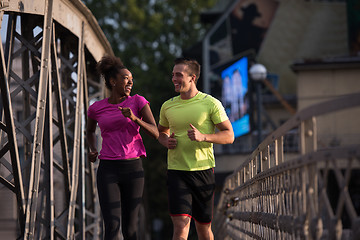 Image showing multiethnic couple jogging in the city