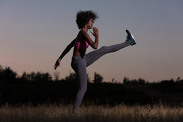 Image showing black woman is doing stretching exercise relaxing and warm up