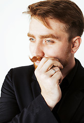 Image showing young red hair man with beard and mustache in black suit on whit