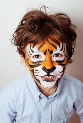 Image showing little cute boy with faceart on birthday party close up, little cute tiger