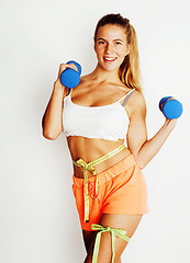 Image showing young pretty slim blond woman with dumbbell isolated cheerful smiling, measuring herself, diet people concept
